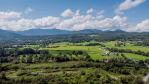 View of Vermont landscape with green hills and valleys and Mount Mansfield. Catamount proudly serves Vermont.